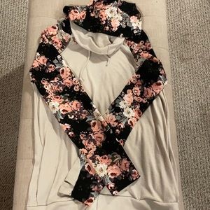 Tan sweater with flowered sleeves and hood.